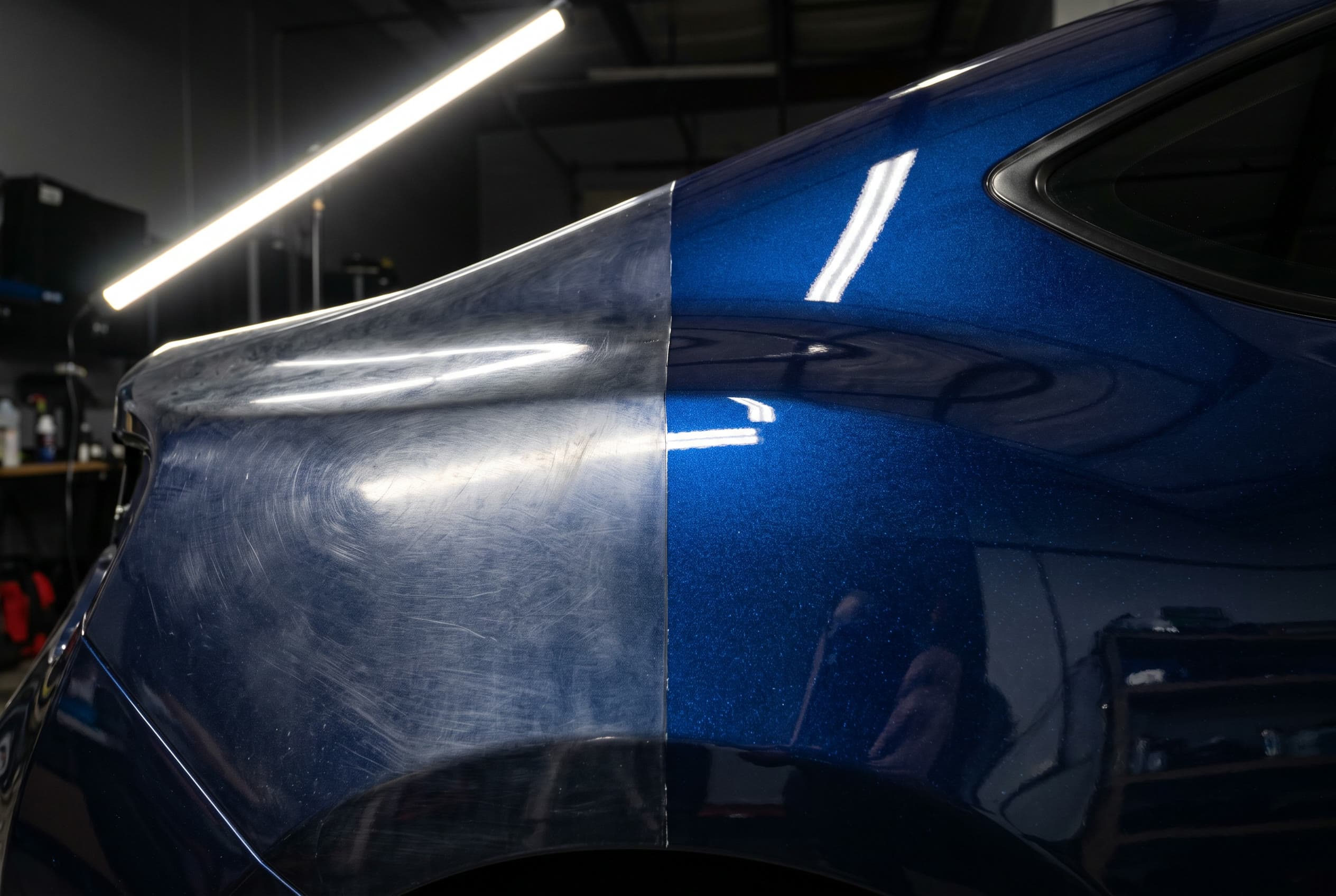 Metallic blue quarter panel split down the middle, hazy on the left, deep and glass-like on the right