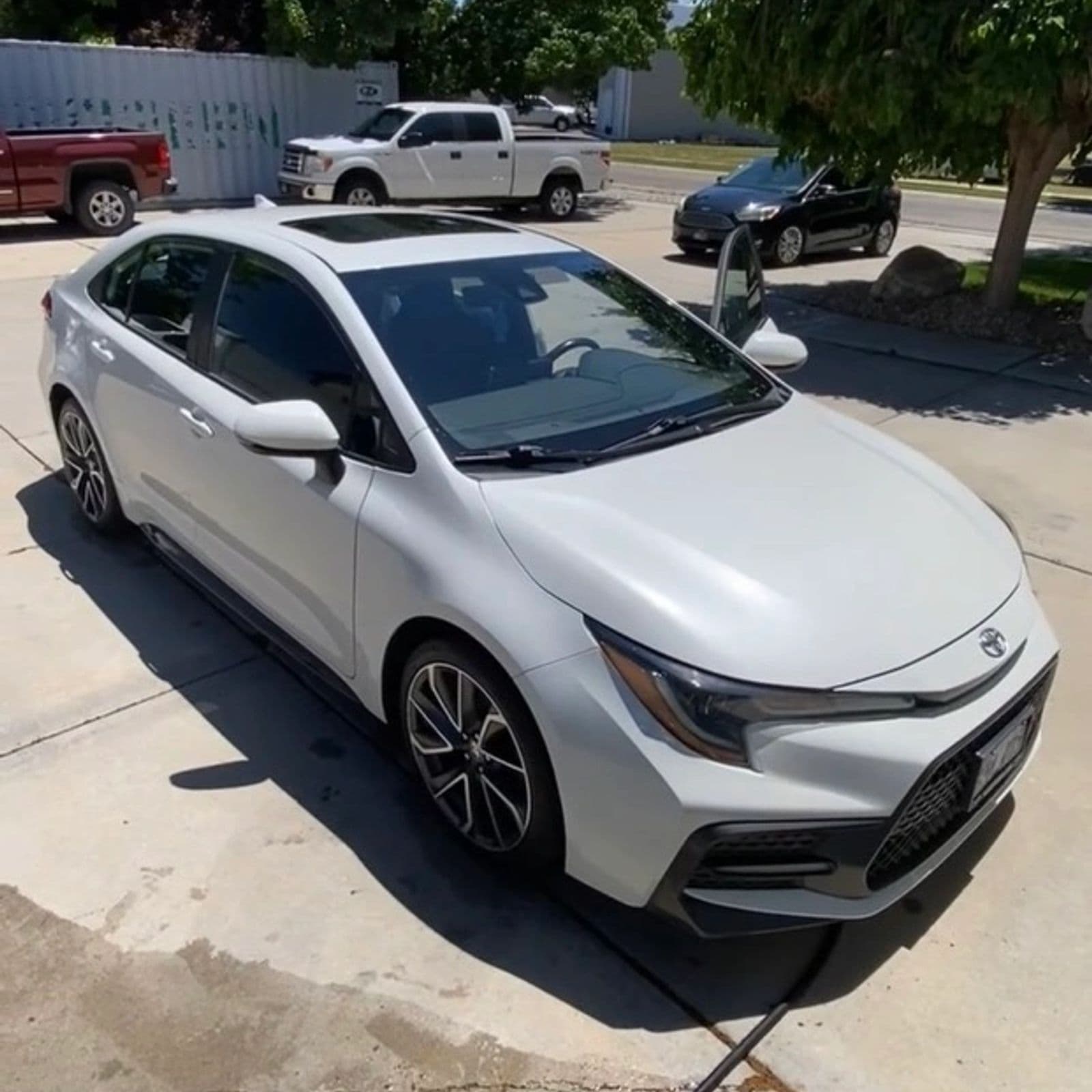White Toyota sedan finished and parked on a residential street, one of Jack's own jobs